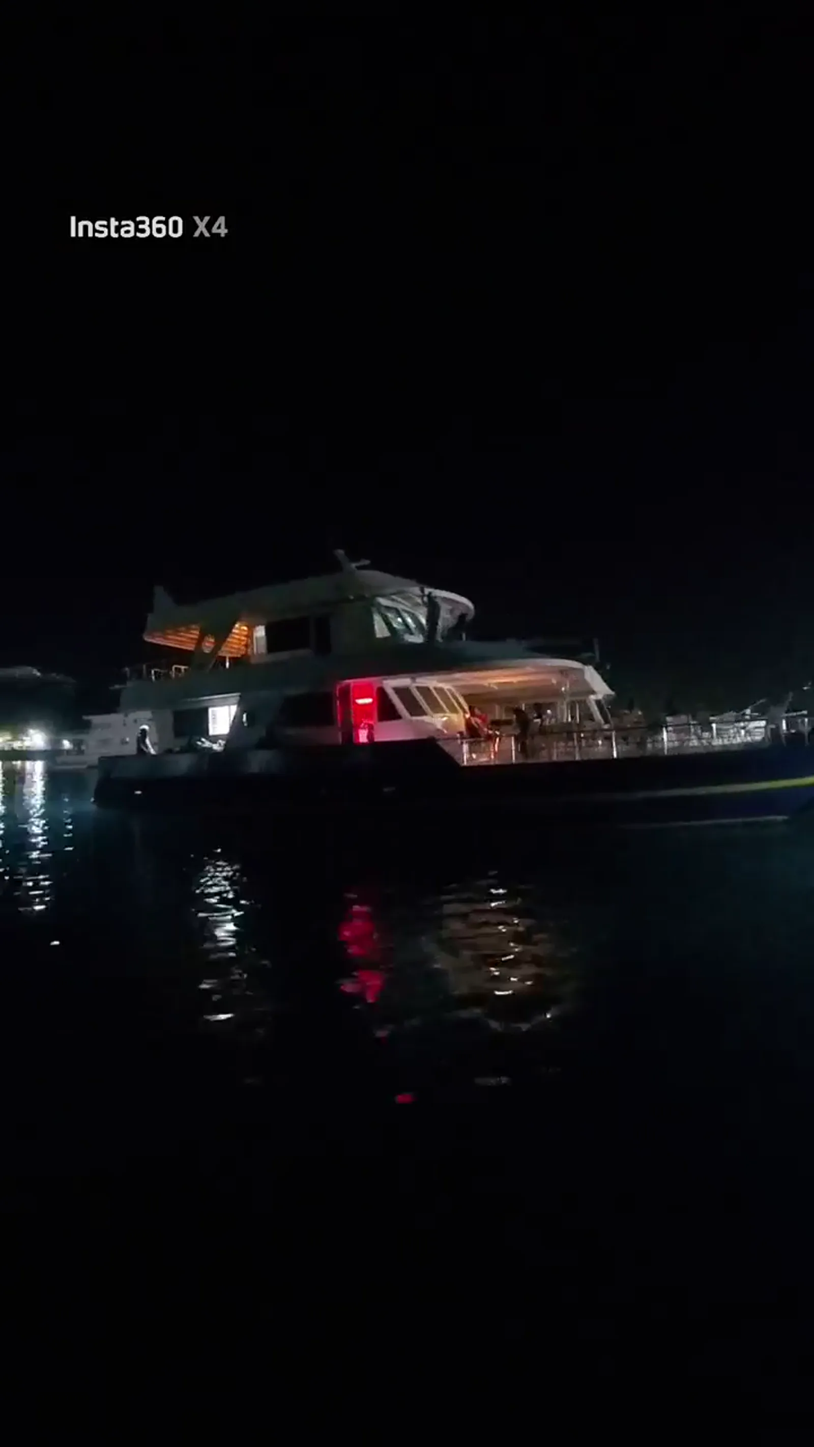 HIDY yacht illuminated beside the marina
